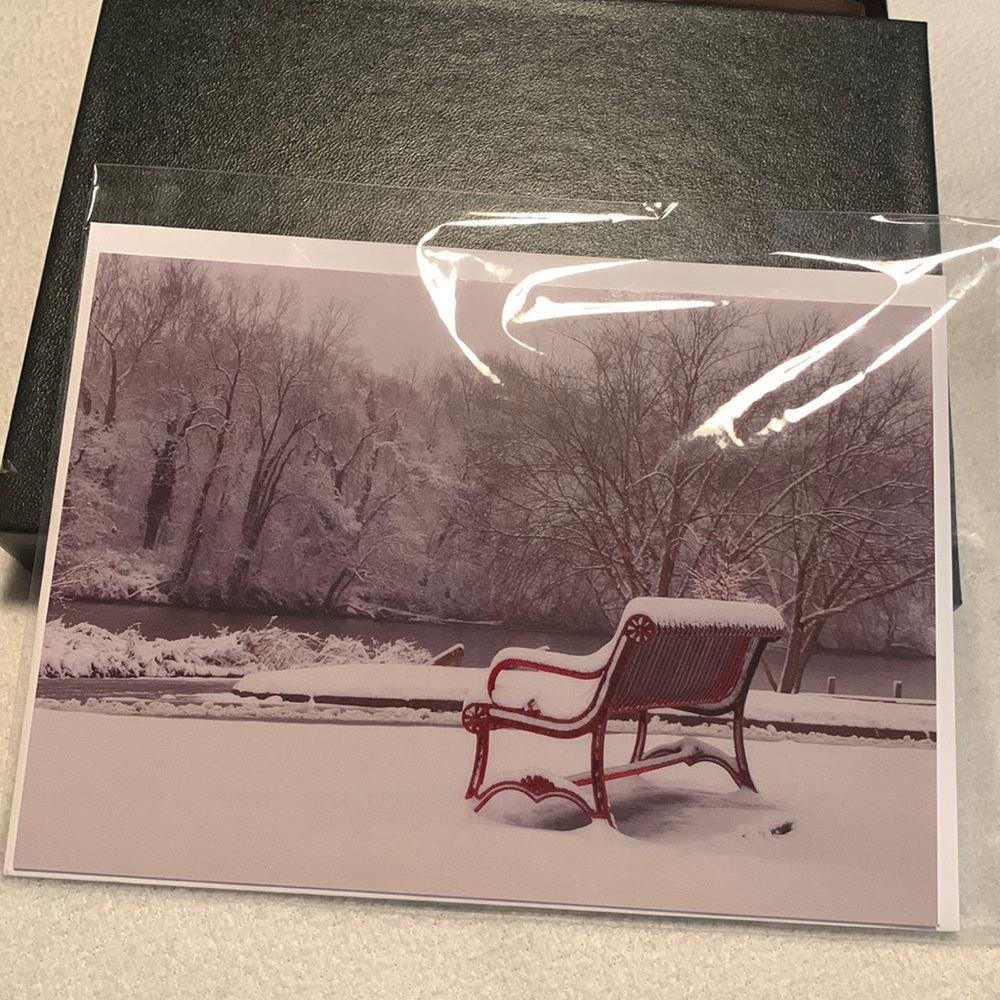 Card of red bench in the snow.